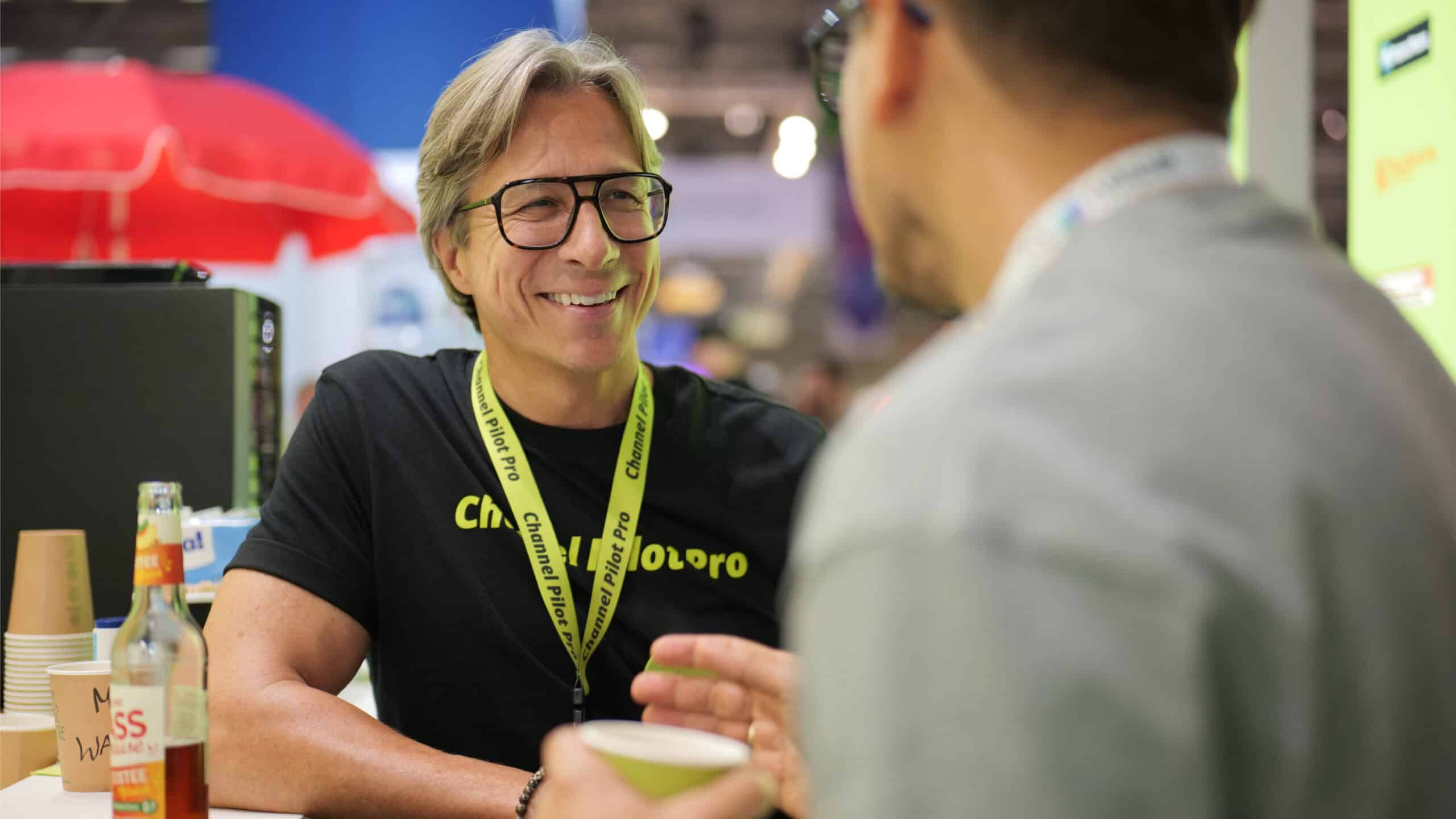 Innovative discussion exchange at a trade fair, friendly interaction between two people.